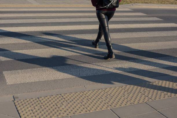 istock Women's legs on a crosswalk. 1388017436