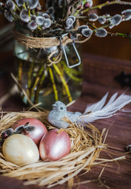istock Pink and yellow Easter eggs in nest on wooden background.  Minimal easter concept. Easter card with copy space for text. 1388018664