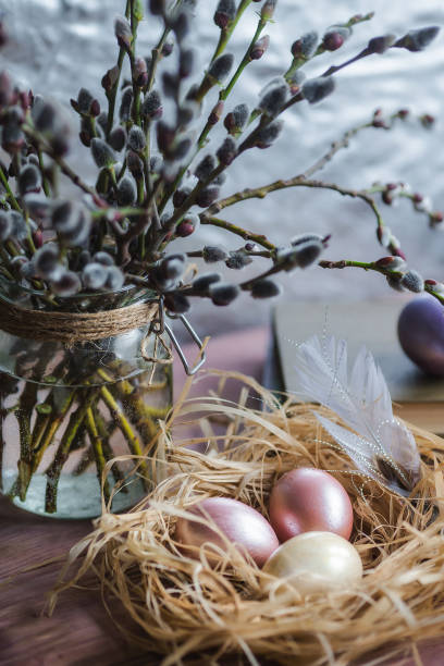 istock Pink and yellow Easter eggs in nest on wooden background.  Minimal easter concept. Easter card with copy space for text. 1388018677
