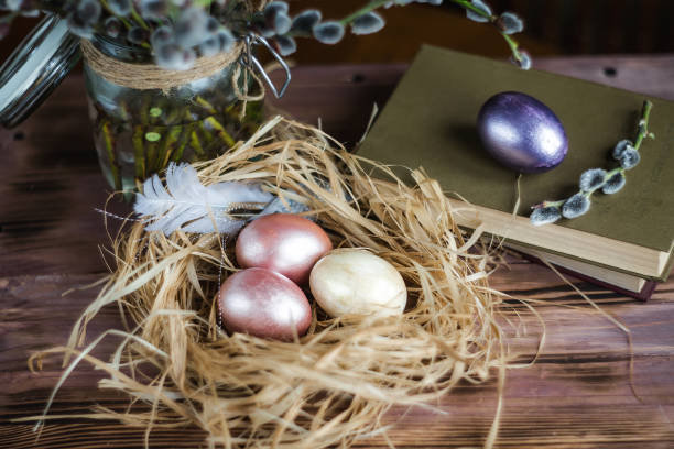 istock Pink and yellow Easter eggs in nest on wooden background.  Minimal easter concept. Easter card with copy space for text. 1388018686