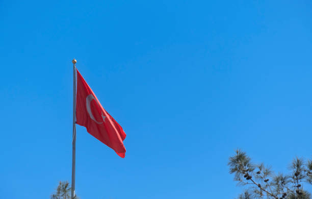 istock Turkish flag waving in the blue sky. Flagpole. 1388019043
