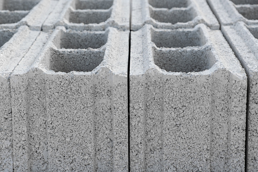 Pallet of Concrete Cinder Blocks, Grey Uniformed brick Shapes building material. New for use  on construction site in Israel.