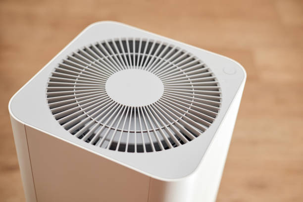 istock White air purifier in an apartment. Close-up, selective focus 1388020691