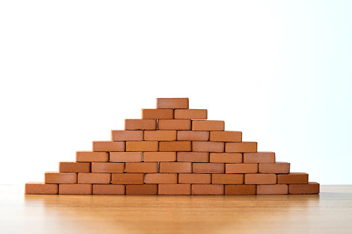 Small brick pyramid on white background.