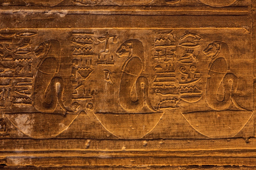 The goddess Menhit with a Uraeus (cobra) body on basket hieroglyphics at the Temple of Edfu in Edfu, Egypt.
