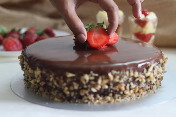 istock Chocolate cake with chocolate ganache and topped with walnut and fresh strawberries 1388023977