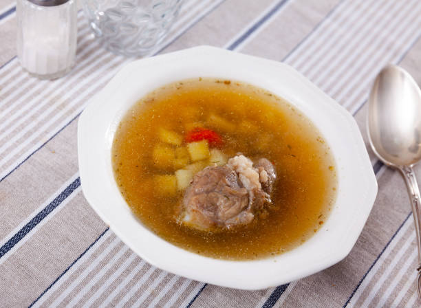 istock Soup in pork broth with potatoes, carrots, onions and herbs 1388024120
