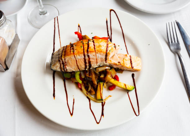 istock Portion of salmon steak with stewed vegetables 1388024457