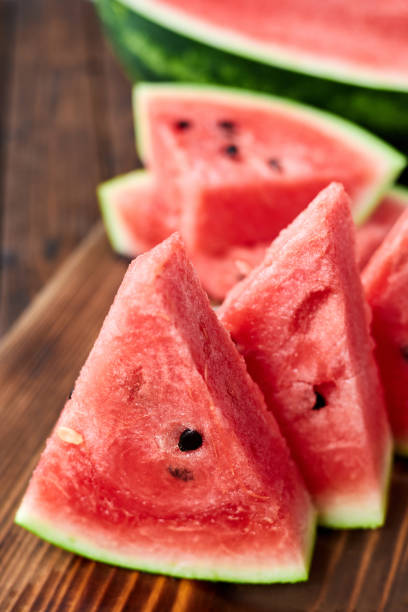 istock Sliced watermelon on brown wooden background. Close-up, selective focus 1388025356