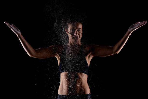 istock Kickboxer kirl with magnesium powder on her hands punching with dust visible.. 1388026772