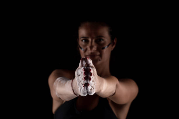 istock Kickboxer kirl with magnesium powder on her hands punching with dust visible.. 1388026773