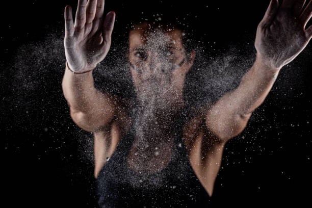 istock Kickboxer kirl with magnesium powder on her hands punching with dust visible.. 1388026781