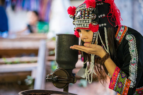 Young woman smelling coffee on her hand. The hill tribes were sniffing the aroma of freshly roasted and ground coffee. stock photo