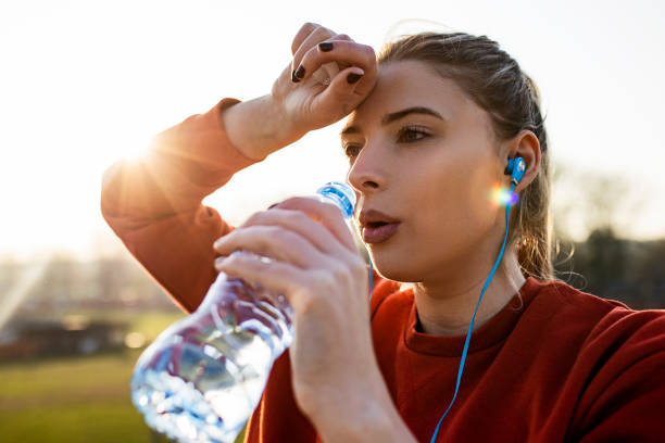 istock Young fit woman hydrating after jogging 1388028050