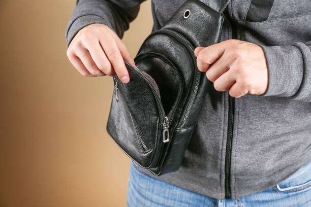 istock men's leather sling bag is on person close up. 1388033539