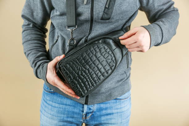 men's leather sling bag is on person