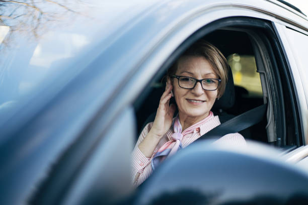 istock Mature woman driving a car. 1388034959