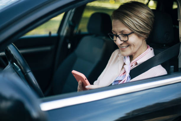 istock Mature woman driving  a car. 1388035025
