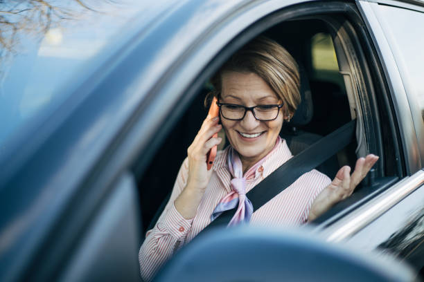 istock Mature woman driving  a car. 1388035154