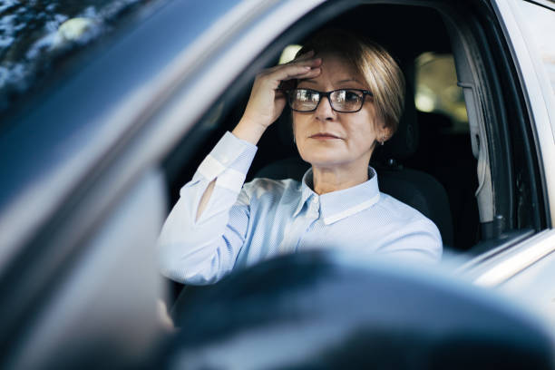 istock Mature woman driving a car. 1388035276