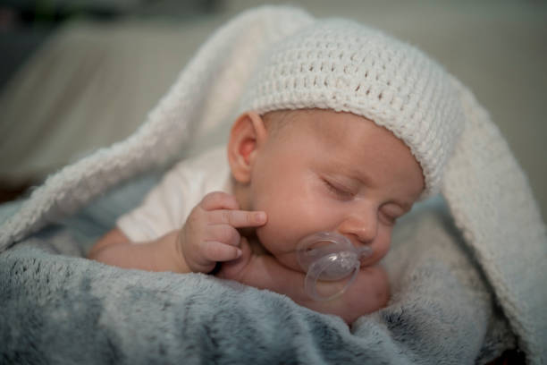 istock Little baby sleeping is making a gesture with his middle finger 1388035352
