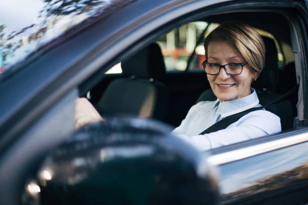 istock Mature woman driving a car. 1388036541