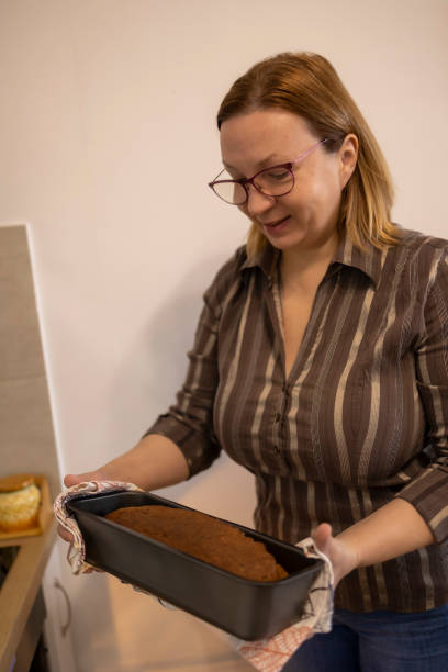 istock Woman with fresh baked sourdough bread 1388036990