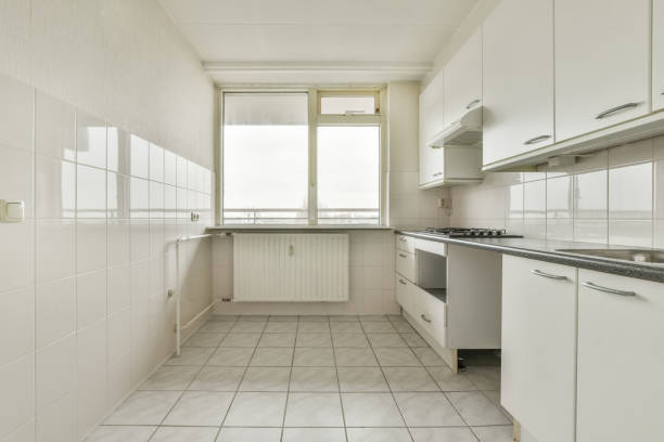 istock Kitchen with white furniture and tiled floor 1388038030