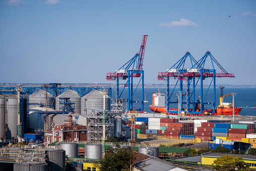 Barcelona, Spain - April 17, 2023: Grimaldi hybrid cargo ship moored at the loading dock with container trailers at the port of Barcelona, Catalonia, Spain