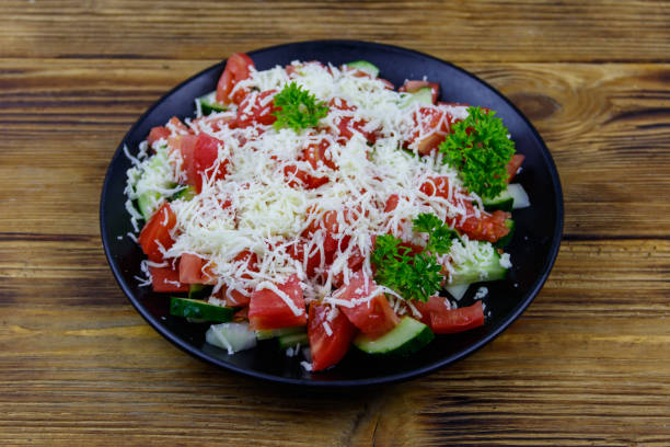 istock Traditional Bulgarian Shopska salad on wooden table 1388038352