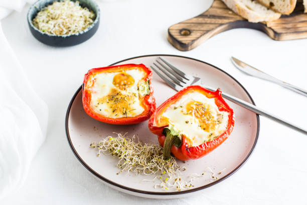 istock Ready-to-eat bell pepper halves baked with egg and microgreens on a plate on the table. Healthy organic diet 1388038427