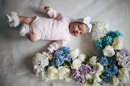 Excited cute little baby girl thinking of something dreaming or having a good idea, smiling and looking up, imagination