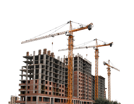 Construction yellow cranes and frame of new multi-storey buildings on a white background