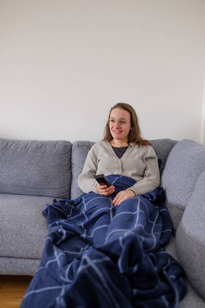 istock Woman watching TV on the sofa 1388047620