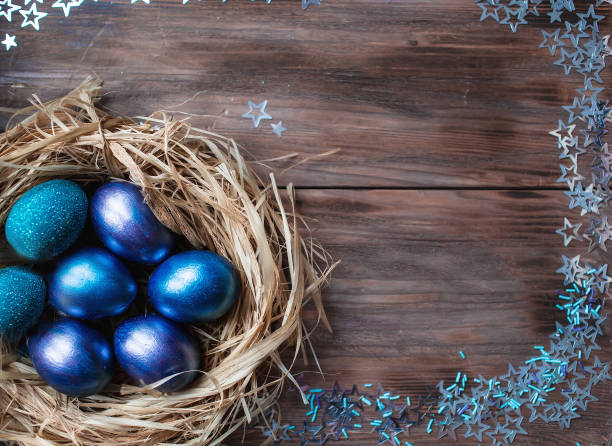 istock Blue Easter eggs in a nest on a wooden background. Easter card with a place to copy the text. The concept of bright Easter. 1388054530