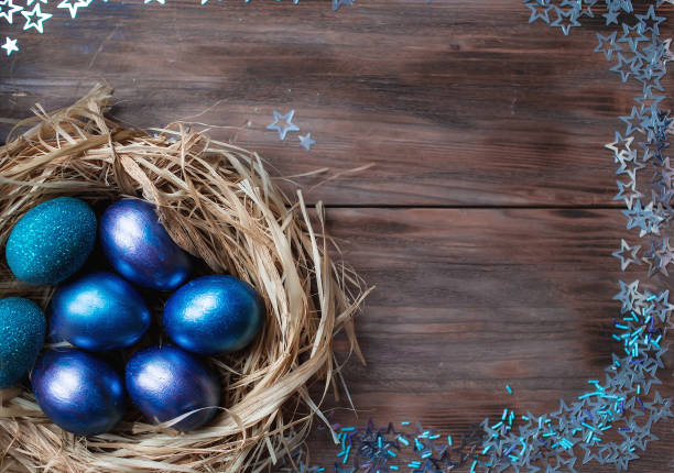 istock Blue Easter eggs in a nest on a wooden background. Easter card with a place to copy the text. The concept of bright Easter. 1388054532