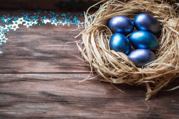 istock Blue Easter eggs in a nest on a wooden background. Easter card with a place to copy the text. The concept of bright Easter. 1388054533
