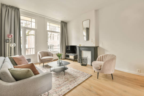 The interior of a spacious living room in an open design with a big sofa and carpet in a cozy house