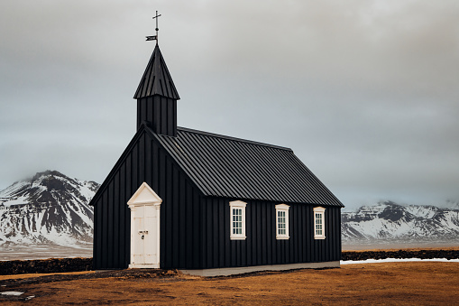 Iconic tiny Black Wooden Church at Budir - Búðakirkja (built in the year 1701) - Budhir Chapel close to the North Atlantic Coast of Snaefellsness in Winter. Black Church, Budir, Snaefellsnes Peninsula, Vesturland, Icelandz