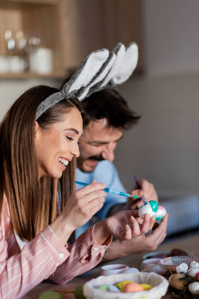istock Attractive young couple painting Easter eggs 1388058768