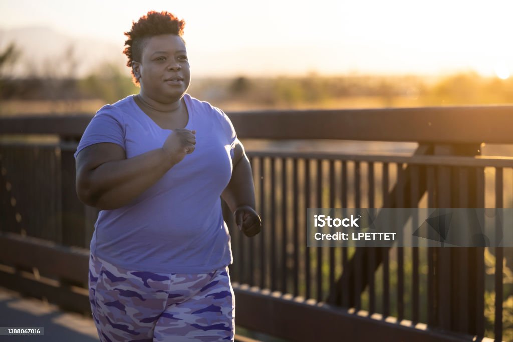 Active Lifestyle An African American woman working out outdoors. Racewalking Stock Photo