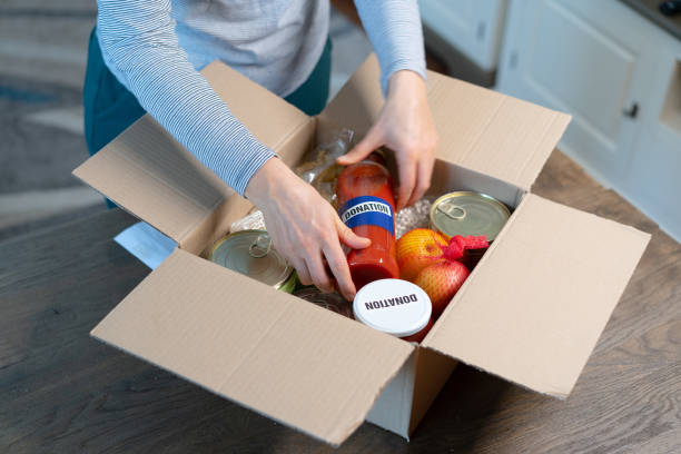 istock People preparing a food box for donation 1388068359