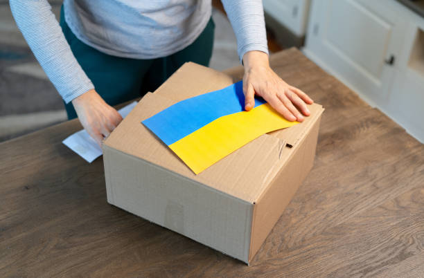 istock An unrecognisable person is closing a donation box . Help for people in need in Ukraine 1388068360