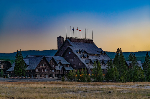 120 year old Old Faithful Inn in Yellowstone National Park at dusk near the Old Faithful geyser in Wyoming in the United States of America (USA).