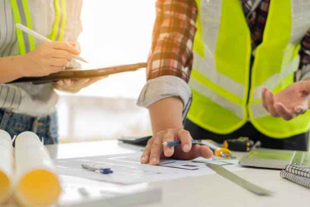 istock A team of young engineers and architects work, meet, discuss, design, plan, measure the layout of blueprints with tabletop tools in the Construction Concepts and Engineer's Offices. 1388078519