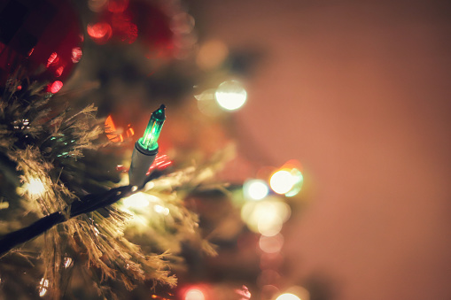A isolated green Christmas tree light with bohek background