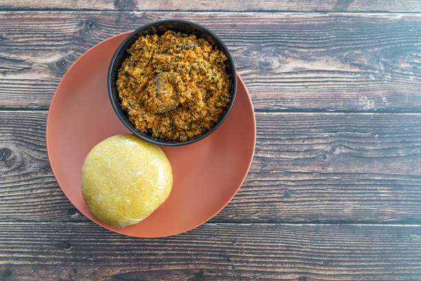istock Nigerian Eba or Garrie Served with Egusi Soup for lunch 1388098018