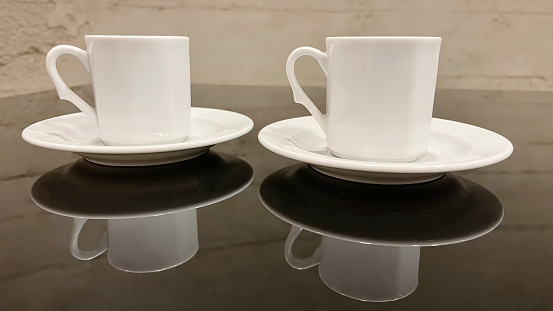 coffee cups on glossy and black background
