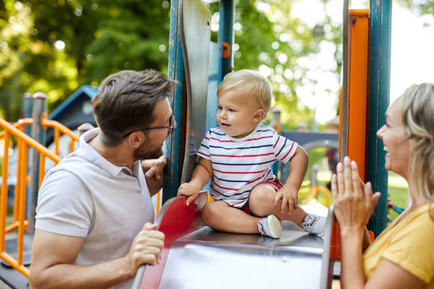 istock Cheerful parents having fun with their son in the playground 1388107393