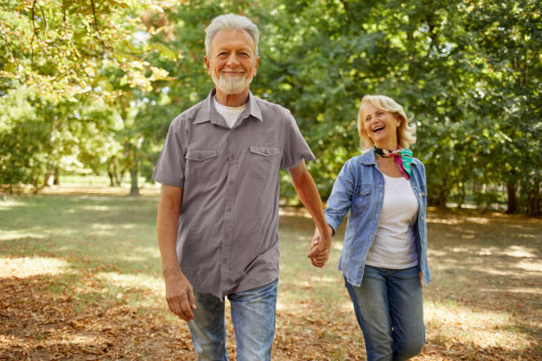 istock Happy senior couple going for a walk in the park 1388107734